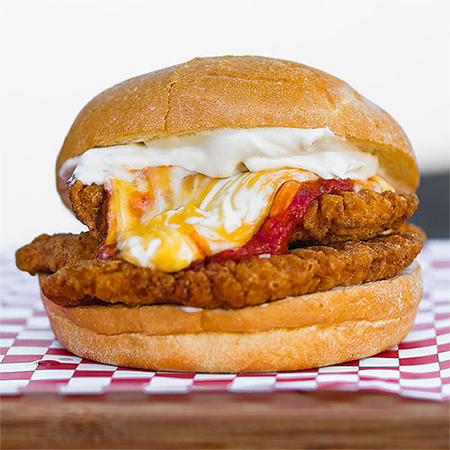 Golden Crispy Fried chicken, Melted Cheese, Garlic Aioli, Marinara Sauce On a fresh Kaiser Roll